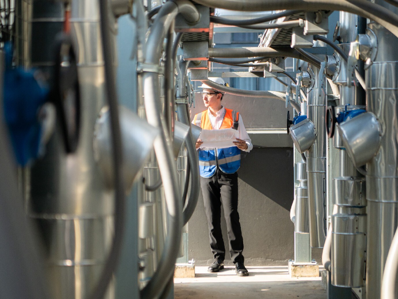 An employee working in a rooftop cooling tower