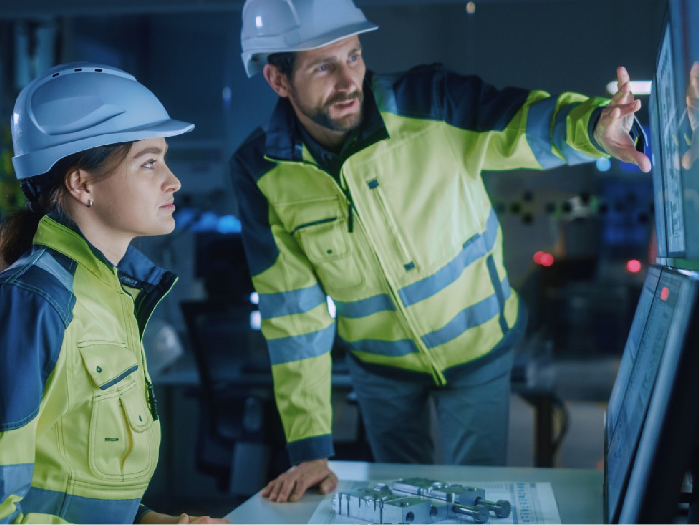 Two workers working in uniform working in a factory
